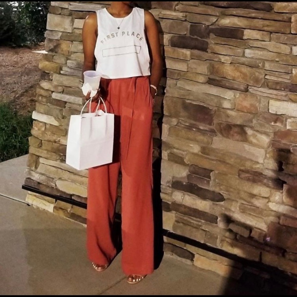 Flaring formal orange pants.